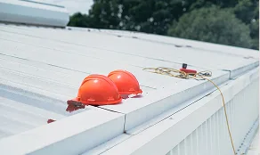 Safety helmets on a metal roof during a free roof inspection
