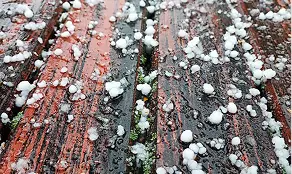 Hailstones covering a wood deck after a Denver hailstorm