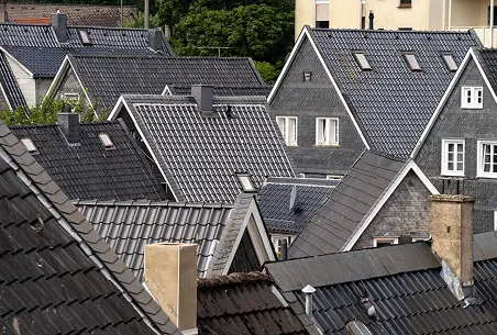 Neighborhood of homes with dark tile roofs maintained by Reliable Roofing